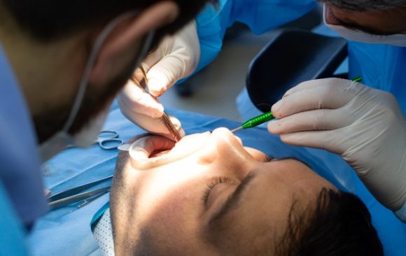 A dentist assistanting during a surgery